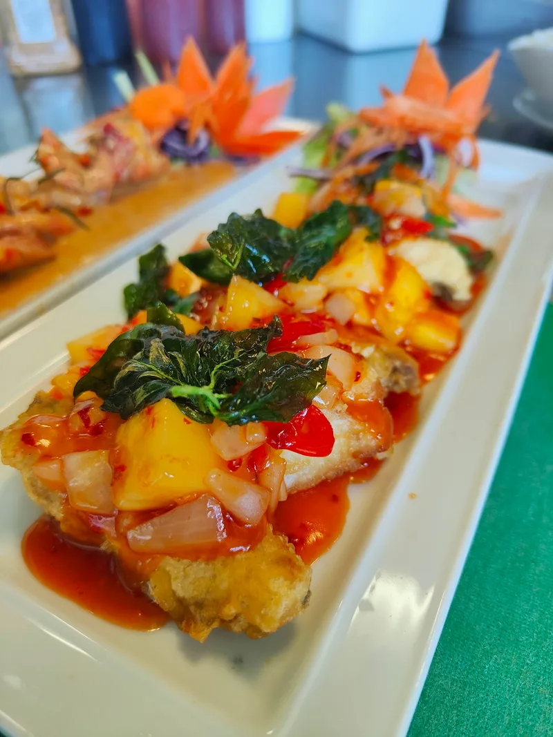 Colourful food served on a long plate at Chokdee